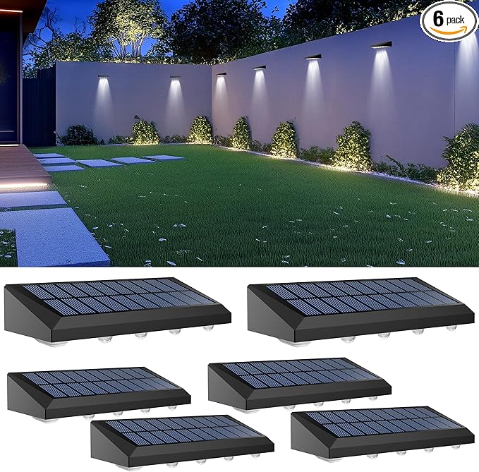 Solar-powered outdoor lights on a grassy area with a wall and pathway in the background.