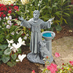 Statue of a religious figure with a bowl in a garden setting