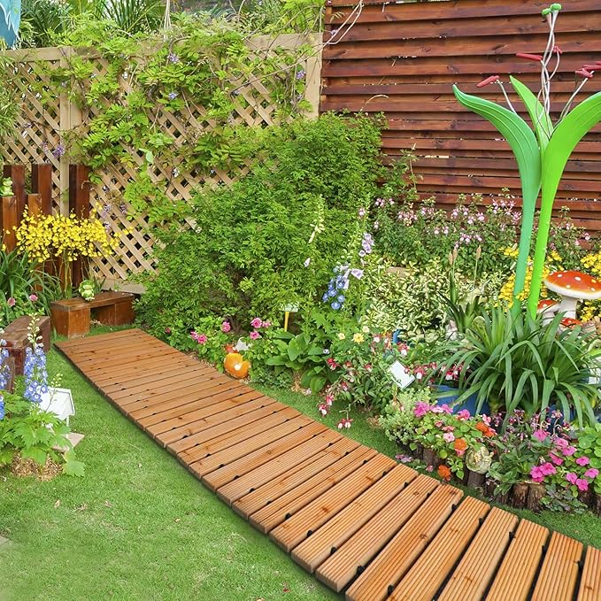 Garden with wooden pathway, plants, and flowers