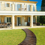 Luxurious house with outdoor seating area and wooden pathway