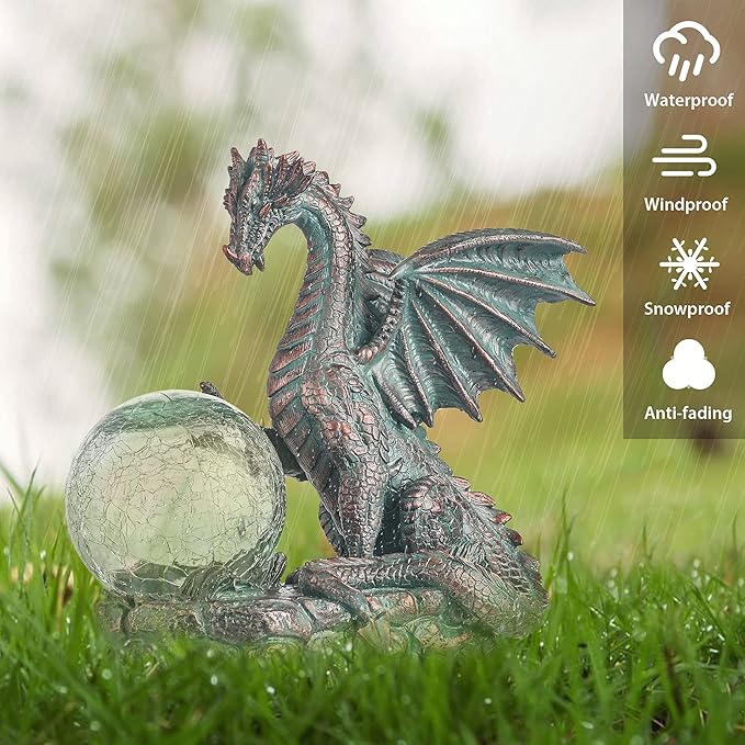 Dragon statue with a crystal ball on grass, featuring weather resistance icons.
