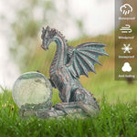 Dragon statue with a crystal ball on grass, featuring weather resistance icons.