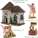 Fairy house with open door, fairy with dog, fairy with cat, and welcome sign on a white background