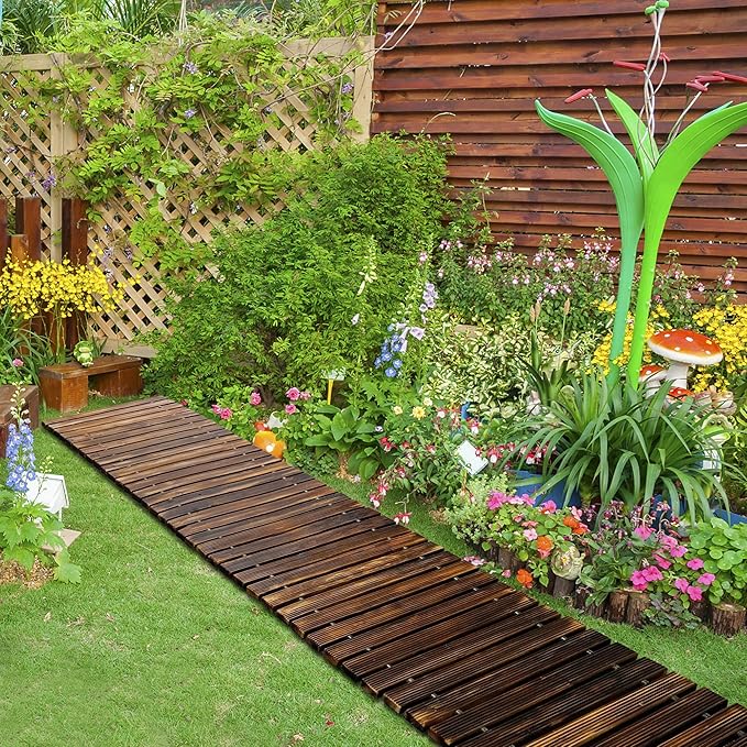 Garden with wooden pathway, plants, and flowers