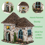 Decorative miniature house with detailed roof and windows on a light green background