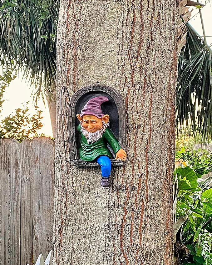 Gnome figurine peeking out from a hole in a tree