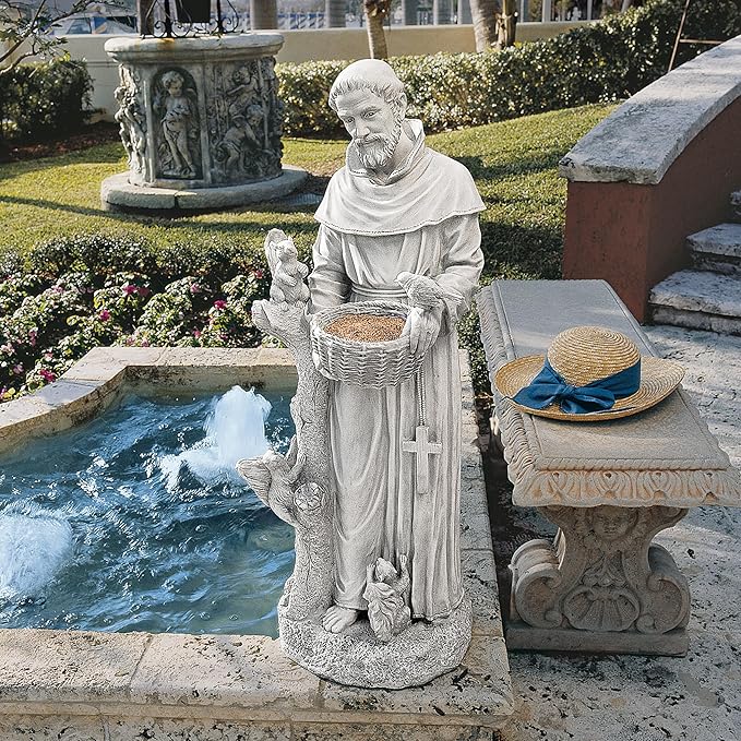 Statue of a religious figure with a basket and hat near a fountain