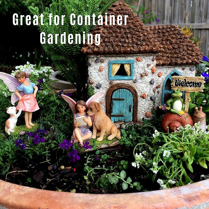 Fairy garden with miniature house, fairies, and animals in a container garden setting.