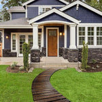 House exterior with a wooden pathway leading to the front door