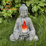 Buddha statue with a red light in a grassy area, labeled 'Weatherproof'.