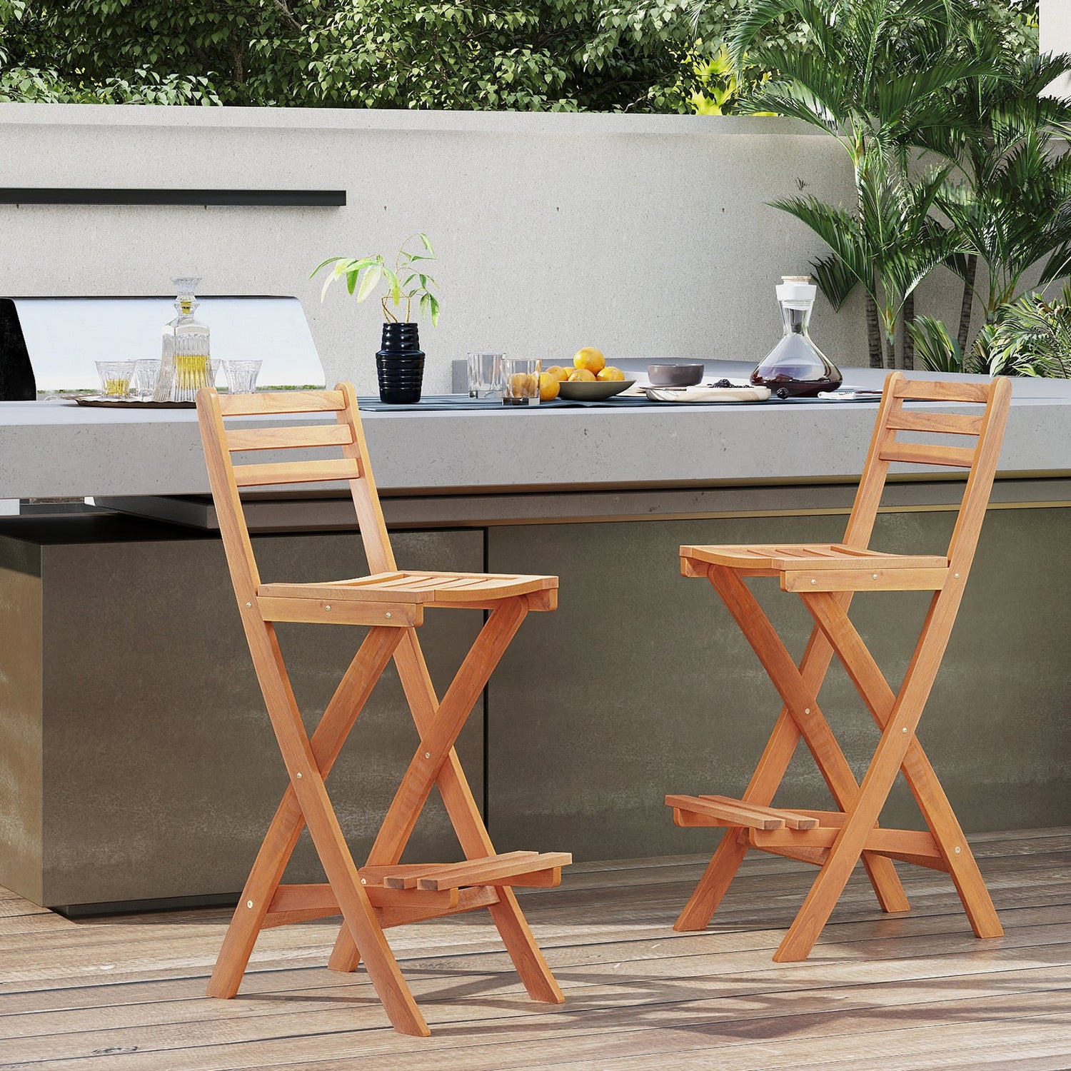 Two wooden bar stools on a patio with outdoor furniture and plants in the background.