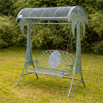 Metal garden swing with canopy in a grassy area
