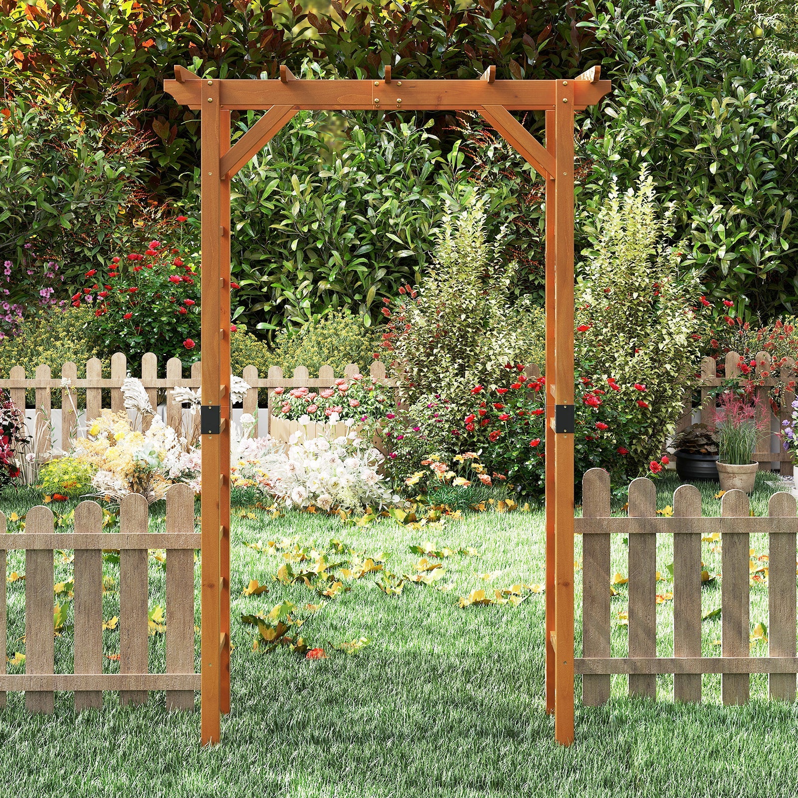 Wooden garden archway in a lush garden setting with flowers and a fence.