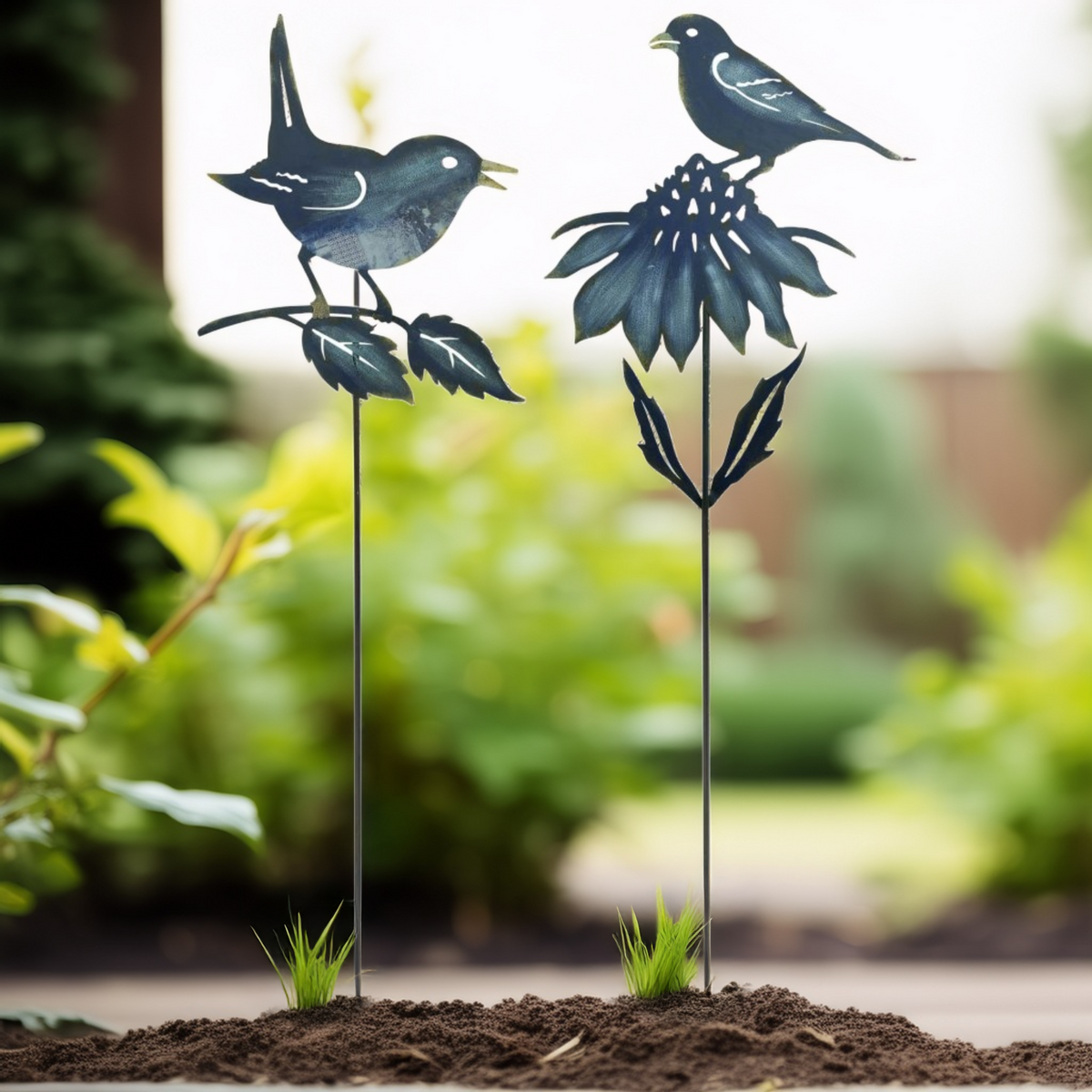 Metal garden stakes shaped like birds and flowers in a garden setting
