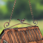 Top of a bird feeder adorned with a little bird