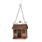 A copper bird feeder against a white background