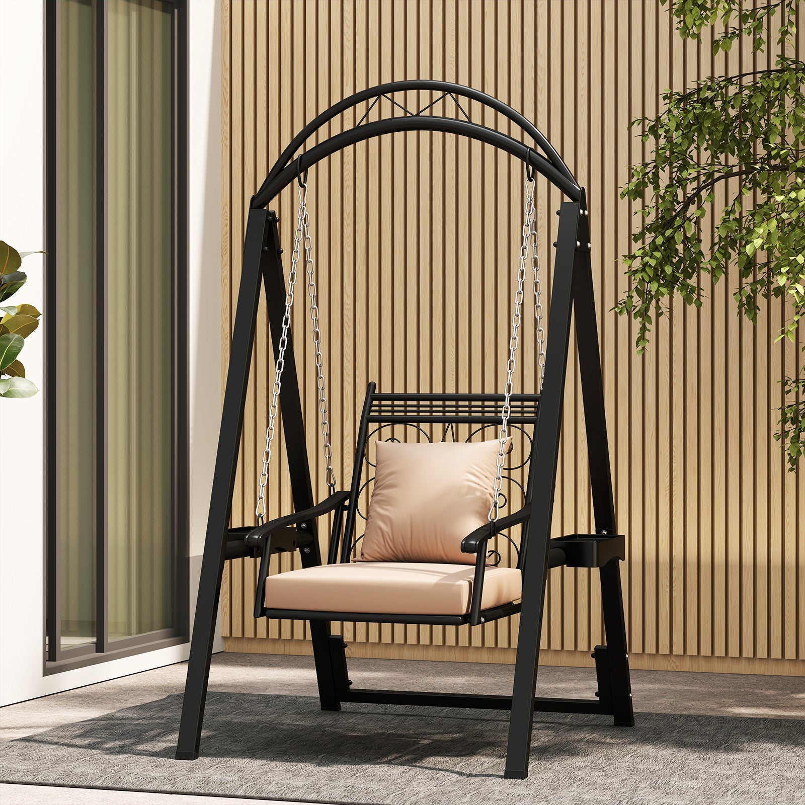 Black metal swing with beige cushion on a patio
