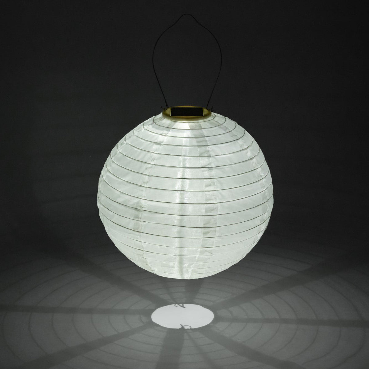 White paper lantern with solar light on a black background
