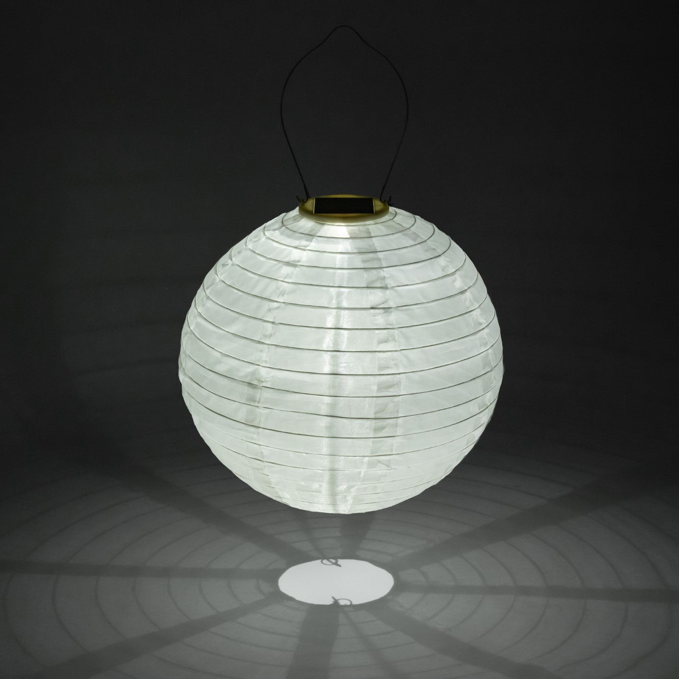 White paper lantern with solar light on a black background