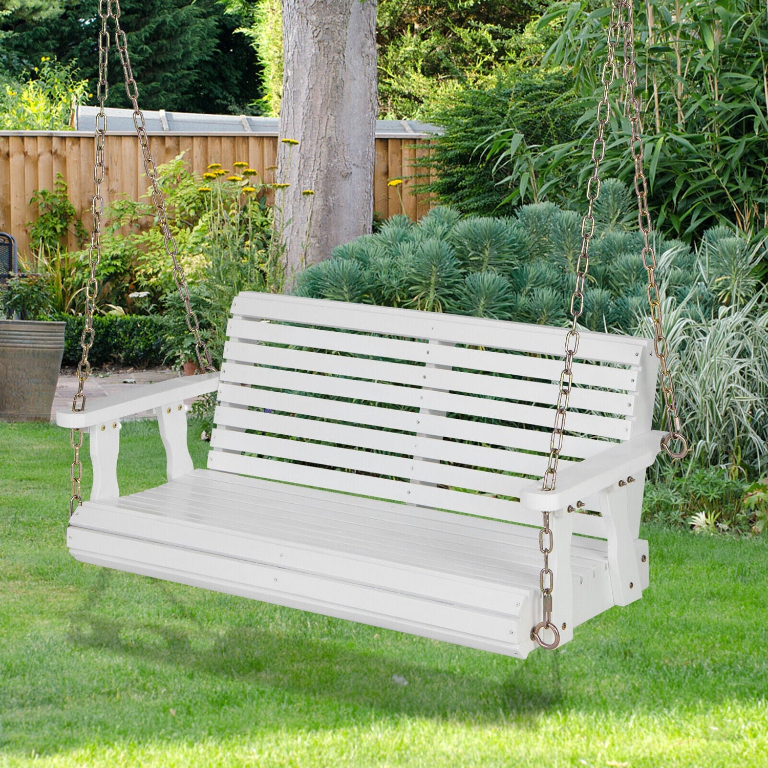 White wooden swing in a garden setting with greenery and a wooden fence.