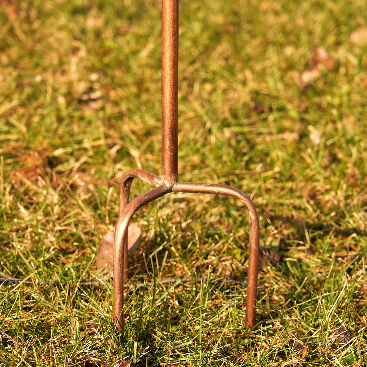 Metal garden fork on grass