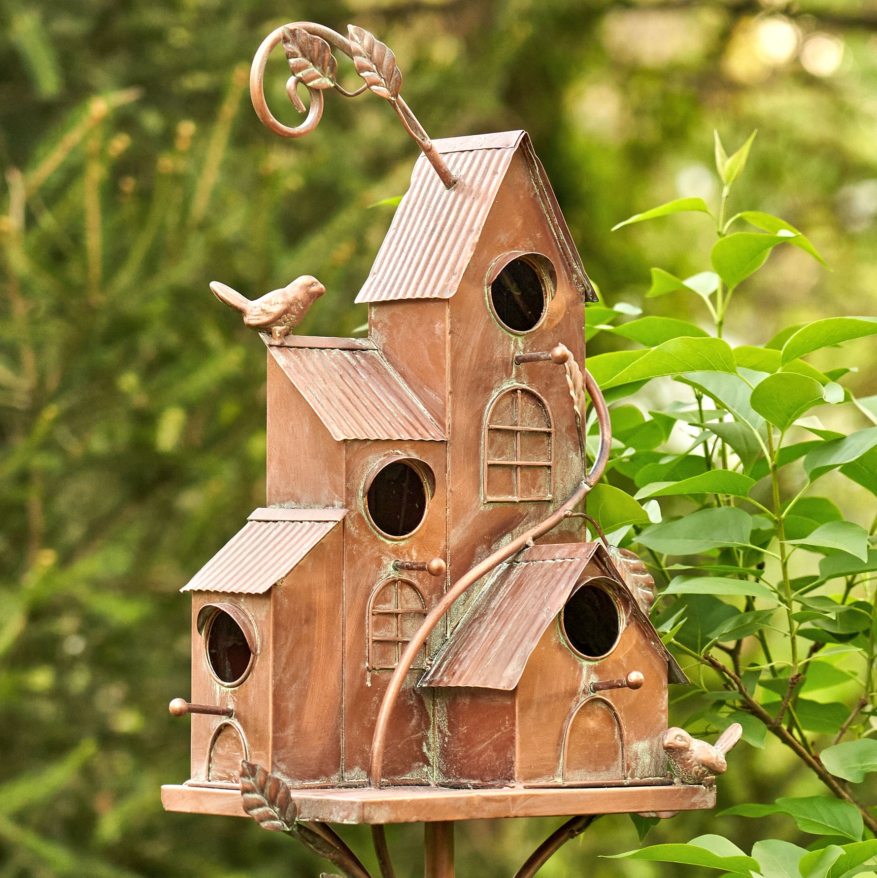 Decorative birdhouse with a rustic design in a garden setting