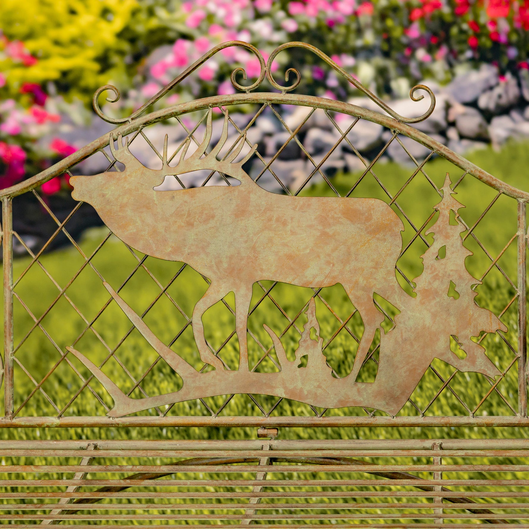 Decorative metal gate with deer silhouette in a garden setting