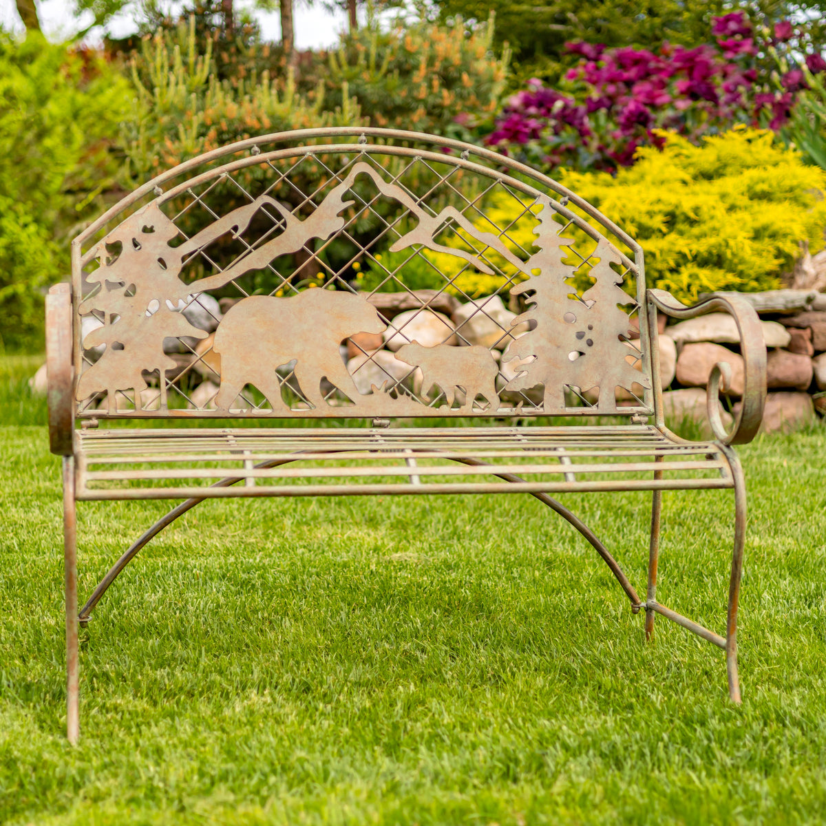 Decorative garden bench with animal cutouts in a garden setting