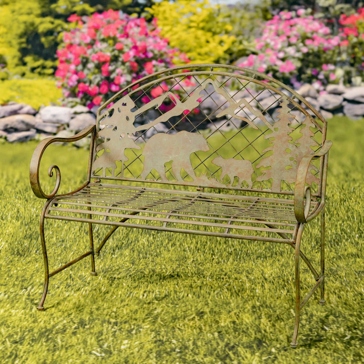 Decorative garden bench with bear design in a grassy area with flowers