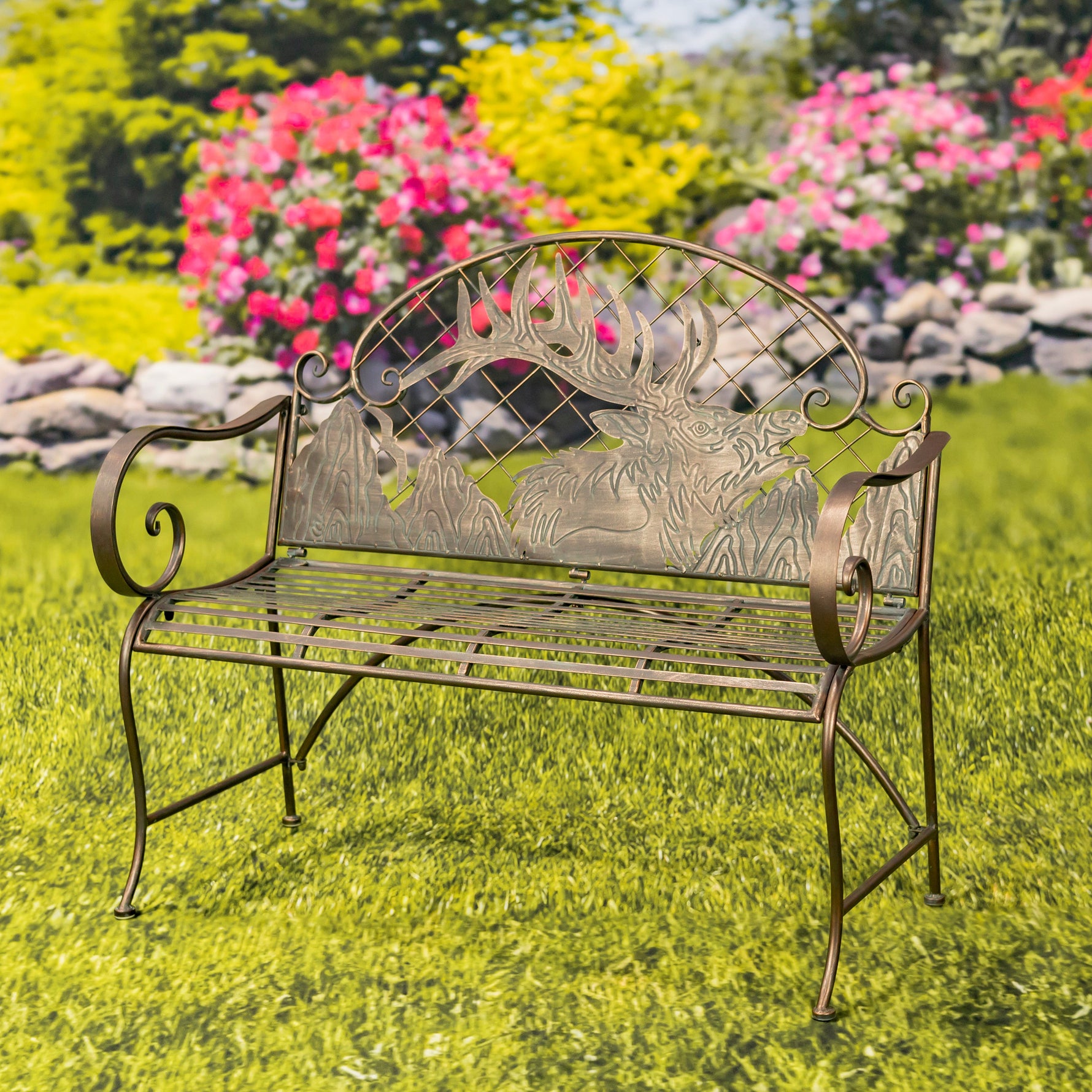 Decorative metal bench with deer design on a grassy area with flowers in the background