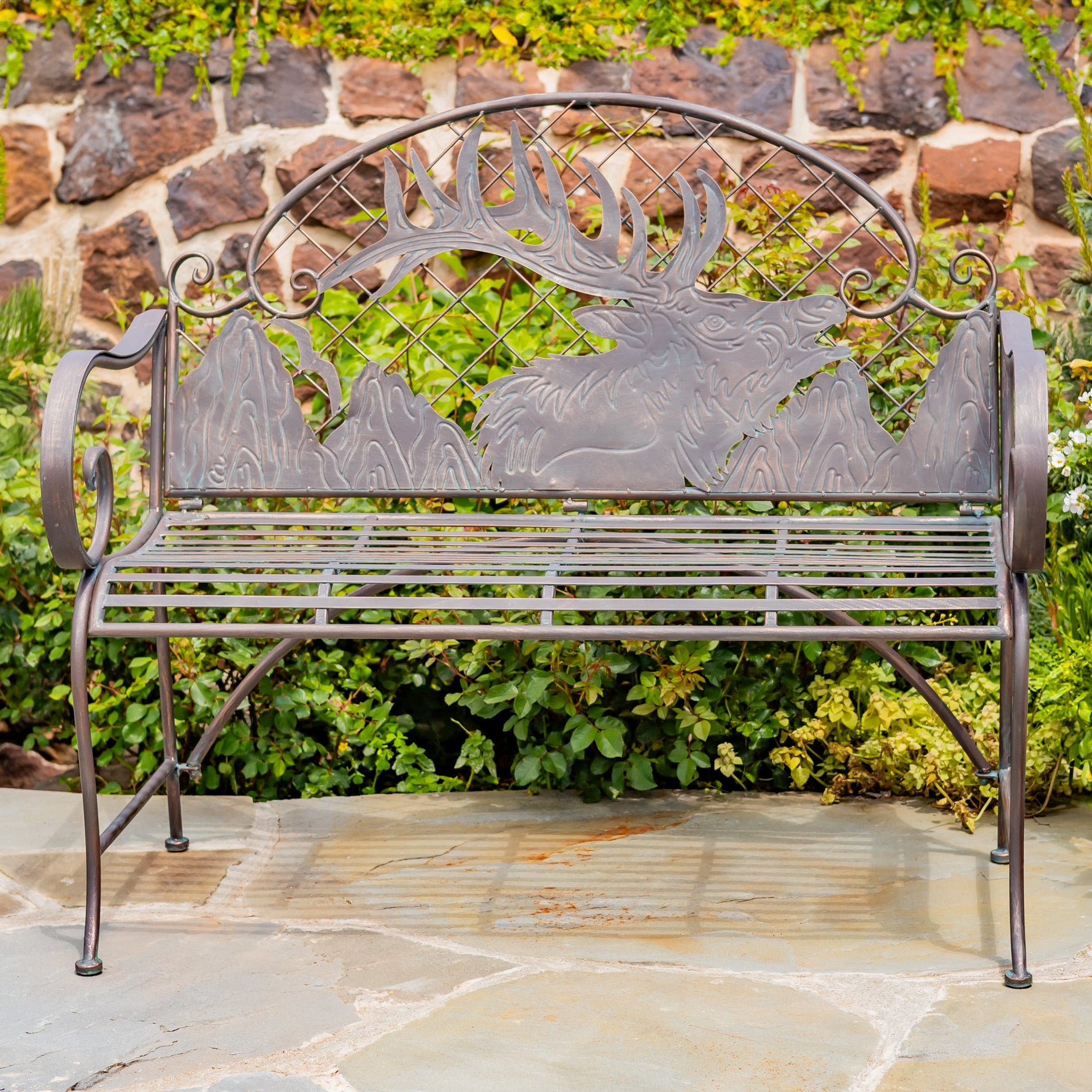 Decorative metal bench with elk design in a garden setting