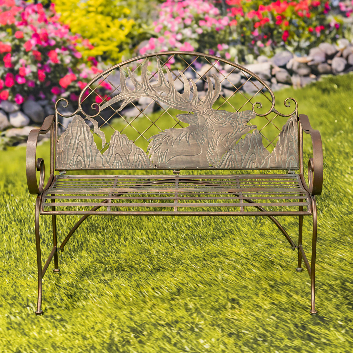 Decorative metal bench with deer design on a grassy area with flowers in the background