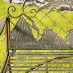 Metallic decorative element with mountain design on a green background