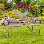 Decorative metal bench with eagle design in a garden setting