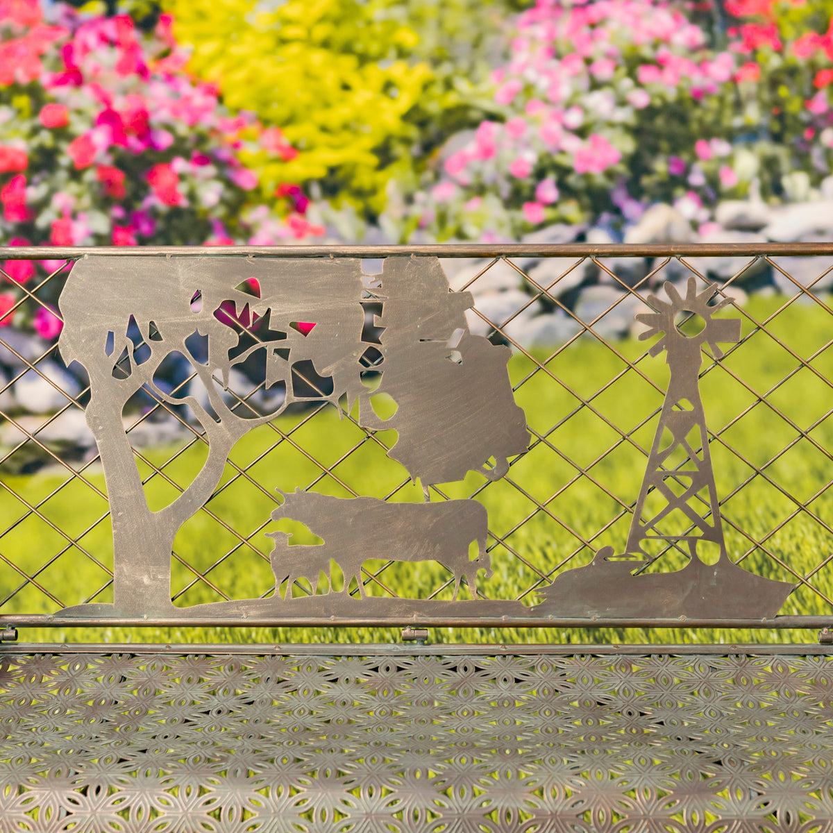 Metallic garden bench with animal cutouts against a floral background