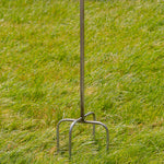 Metal garden fork on a grassy background