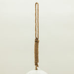 White ceramic object with a rope handle on a light beige background