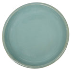 Round ceramic plate with a teal glaze on a white background