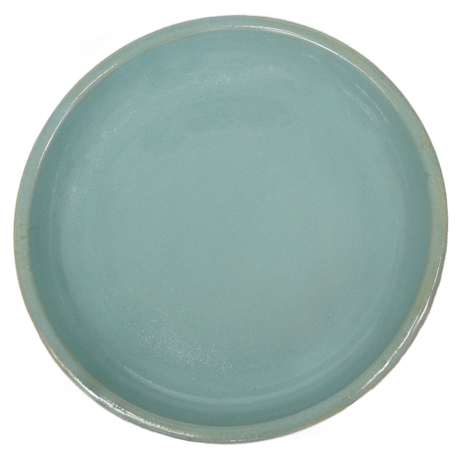 Round ceramic plate with a teal glaze on a white background