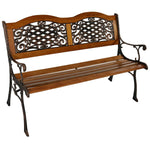 Wooden bench with decorative metal backrest on a white background