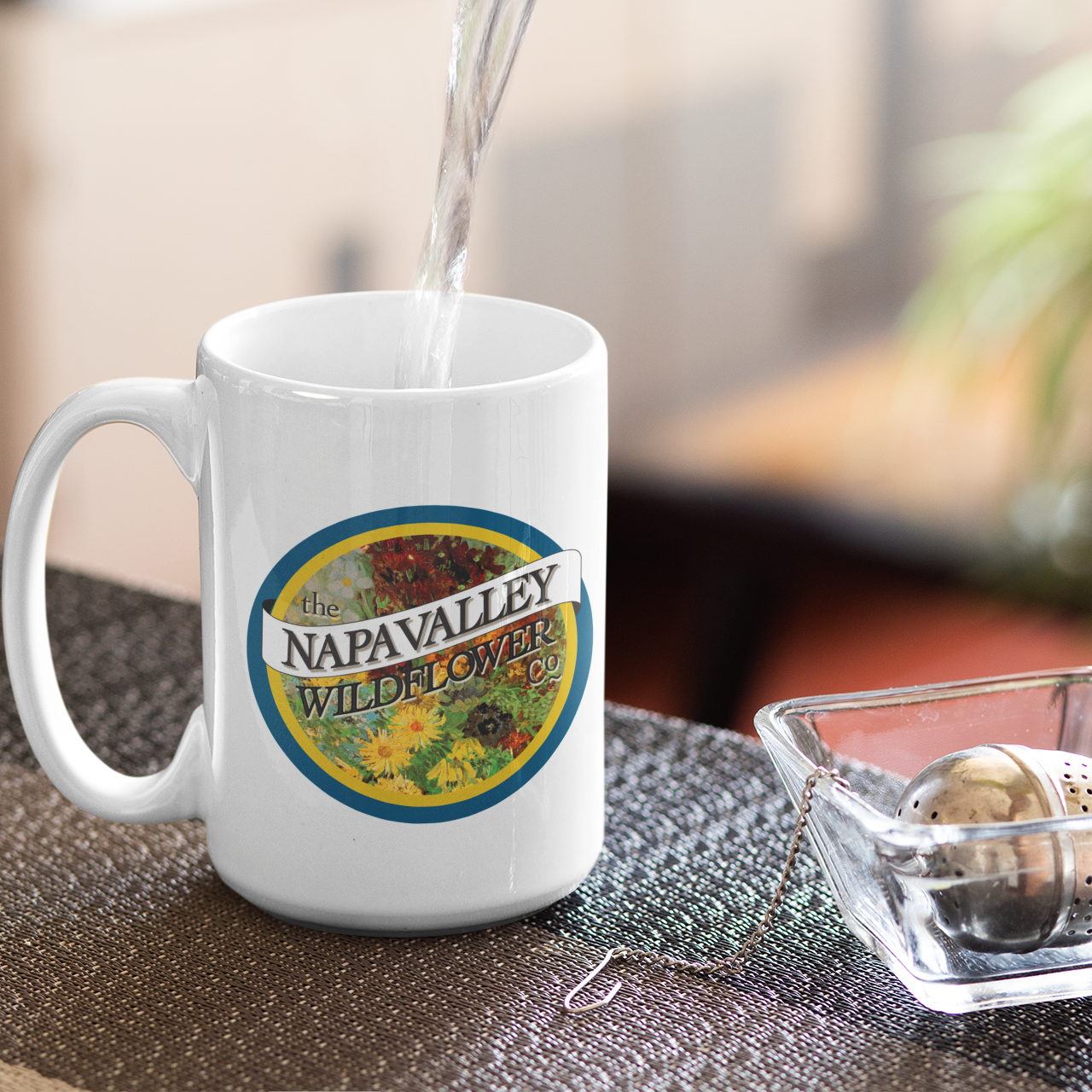extra large White mug with a logo on a table with a blurred background