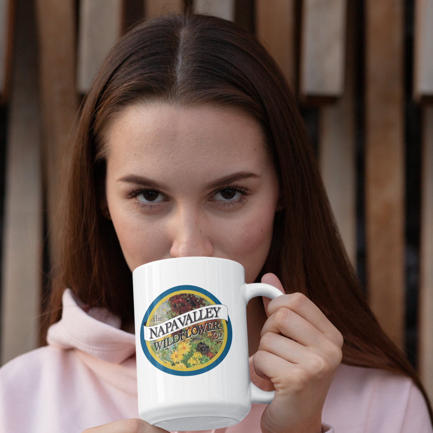 Woman holding an extra large white mug with a 'Napavalley Wildflower' logo.