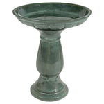 Green ceramic bird bath on a white background
