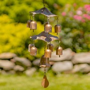 Decorative wind chime with bells in a garden setting