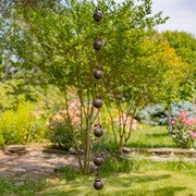 Decorative hanging orbs in a garden setting