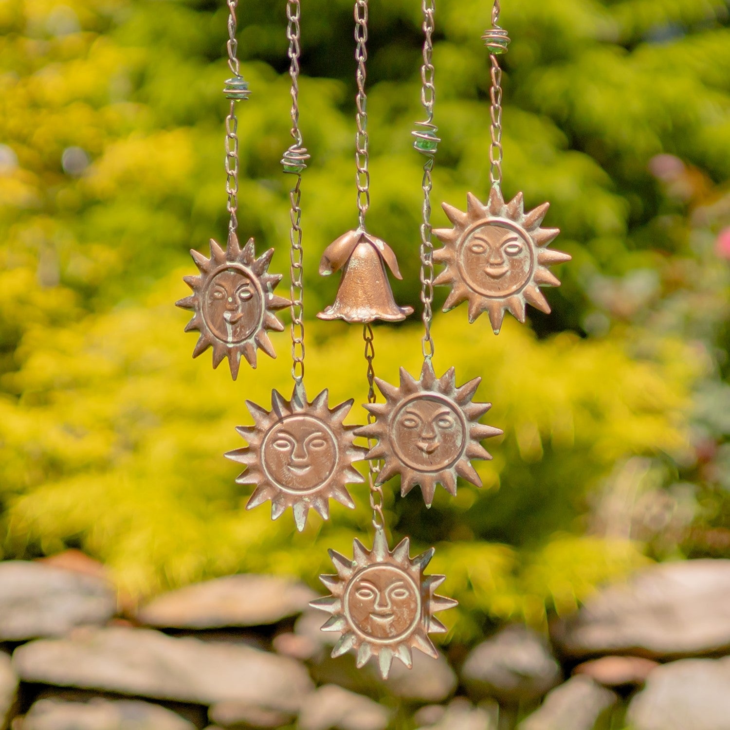 Decorative hanging sun and bell ornaments with a natural background