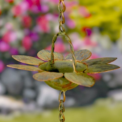 Decorative metal hanging flower with a blurred floral background
