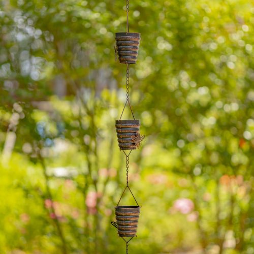 Decorative hanging planters with a blurred garden background