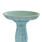 A ceramic pedestal birdbath with a textured, distressed light blue and turquoise glaze, shown against a plain white background.