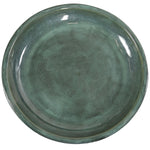 Green ceramic plate on a white background